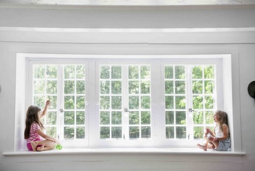 Windows in a family room with two children